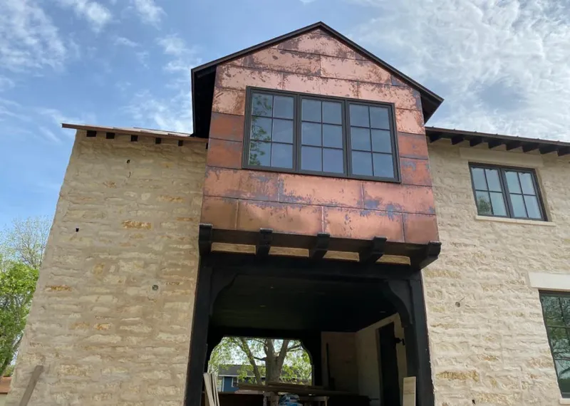 Copper metal panel facade on a stone building for Roof Repair in New Port Richey East